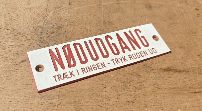 Sporvognsskilt. Nødudgang. Træk i ringen. Tryk ruden ud